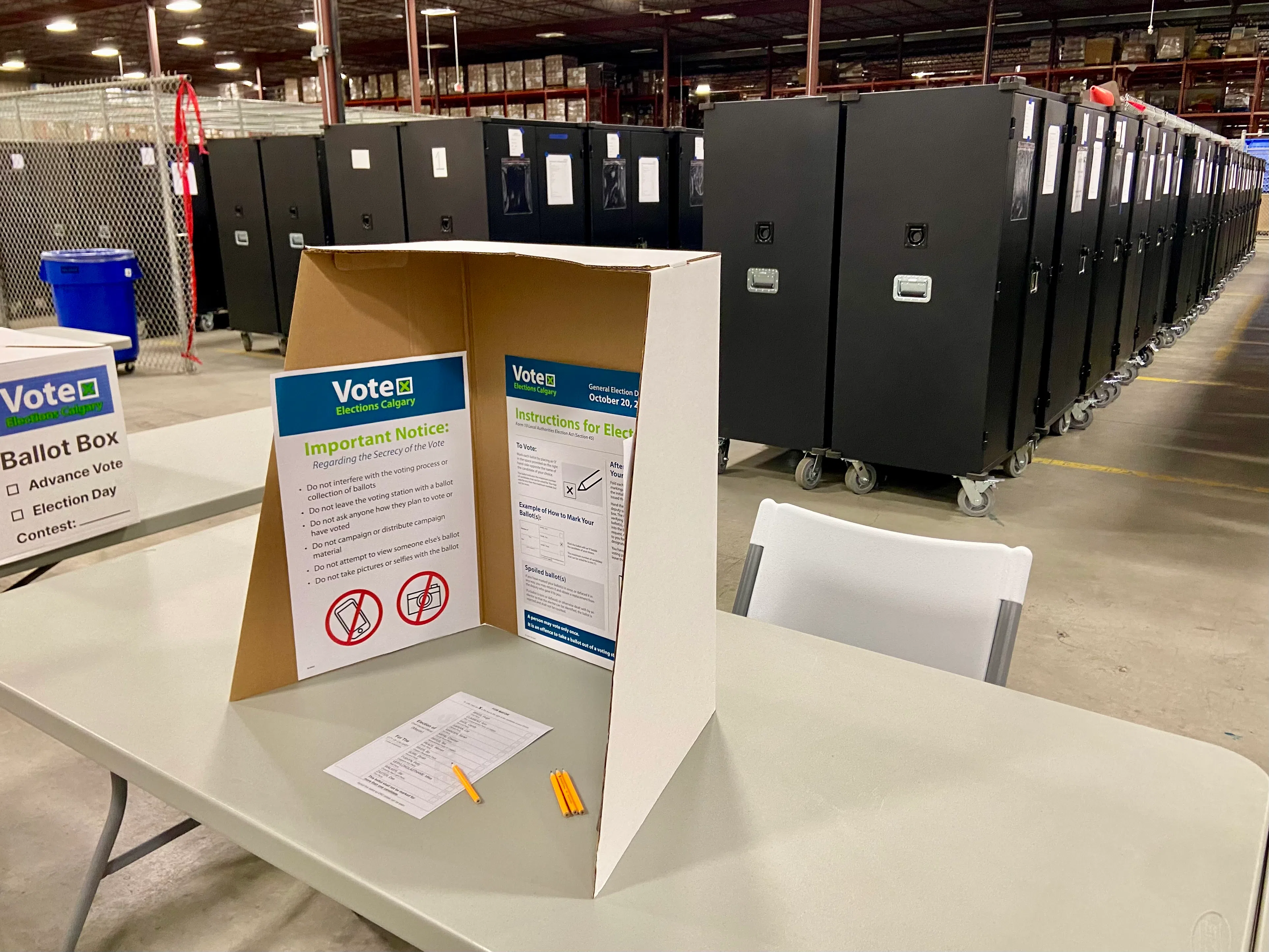 A voting station pre-setup, with the new ballot lockers behind it, and one of the official voting boxes on the left. Photo by William L. Baliko