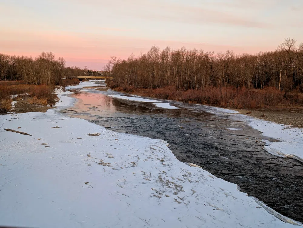 The Sheep River flows under a beautiful sky