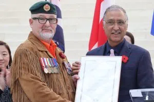 Chuck Issacs, President of the Aboriginal Veterans Society of Alberta (Left) and Edmonton Mayor Amarjeet Sohi holding up the proclamation for Indigenous Veterans Day inside City Hall (Photo Credits - Daniel Barker-Tremblay)