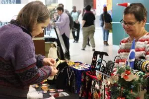 Shopper checking out some hand made merchandise at the Metis Market (Photo Credits - Daniel Barker-Tremblay)