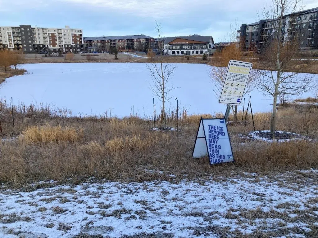 Stormwater facility in Edmonton with a warning sign from EPCOR (Photo Credits - EPOR)