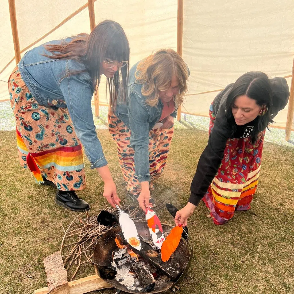 Hunting Hills Staff members burning designed eagle feathers (Photo Credits - Hunting Hills High School)