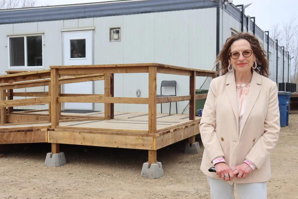 Lenora LeMay, Board Chair of the Lakeland Out of the Elements Shelter Society in front of the newly built Transitional Housing Facility in Lac La Biche (Photo Credits - Daniel Barker-Tremblay)
