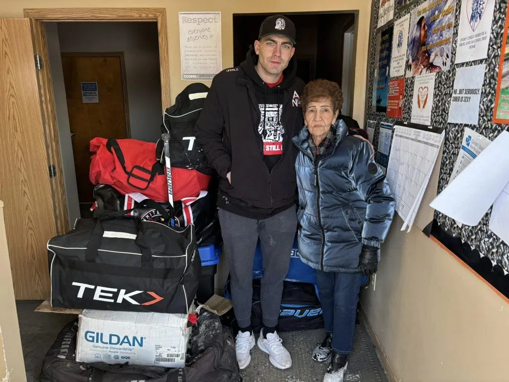 ANH Founder Mason Mitchell (Left) and Mary Mitchell (Right) together in front of the 10K worth of donated hockey equipment (Photo Credits - Daniel Barker-Tremblay)