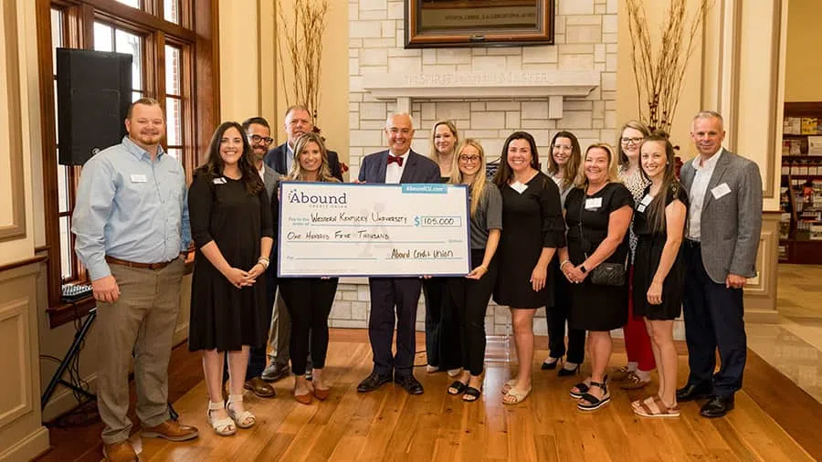WKU President Timothy C. Caboni (center) with Ray Springsteen, President/CEO of Abound Credit Union (right), and Abound Credit Union team members