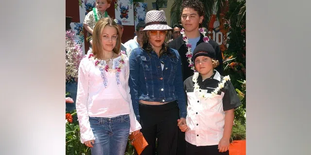 Lisa Marie Presley and her children Benjamin Keough (R), Riley Keough (L), and her half-brother Navarone Garibaldi (back) attend the premiere of "Lilo and Stitch" at the El Capitan theatre in Hollywood on June 16, 2002.
