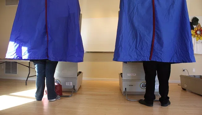 FILE -- Voters stand inside voting booths at a polling place in Philadelphia, Pennsylvania on Election Day, November 2, 2010.