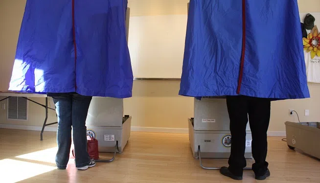 FILE -- Voters stand inside voting booths at a polling place in Philadelphia, Pennsylvania on Election Day, November 2, 2010.