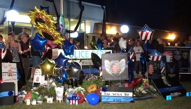 Residents and fellow police officers gather at the Fox Lake, Illinois Police Department on September 2, 2015, to remember the life of Lt. Joe Gliniewicz. Gliniewicz was shot and killed on Tuesday while chasing three suspects.