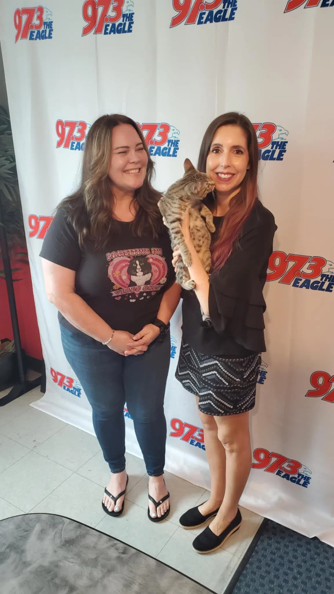 Katie from Billy the Kidden Rescue poses with Abby the cat and Stephanie Taylor in the 97.3 The Eagle studio