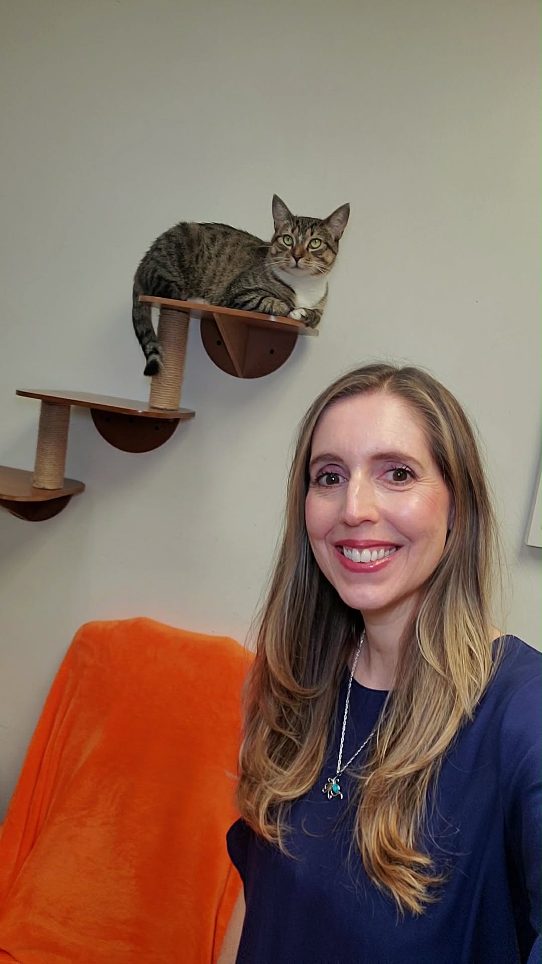 Stephanie Taylor poses with a gray tabby cat