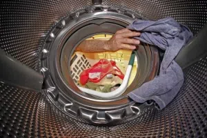 FILE - In this Thursday, July 19, 2012 file photo, a load of laundry is loaded into a whirlpool washing machine in Pittsburgh. Whirlpool said Tuesday, Aug. 13, 2013, it is buying a majority stake in Chinese appliance maker Hefei Rongshida Sanyo Electric Co. Ltd. for about $552 million. (AP Photo/Gene J. Puskar, File)
