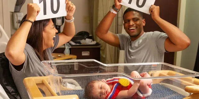 Parents celebrating their newborn's birth amid the Tokyo Olympics.