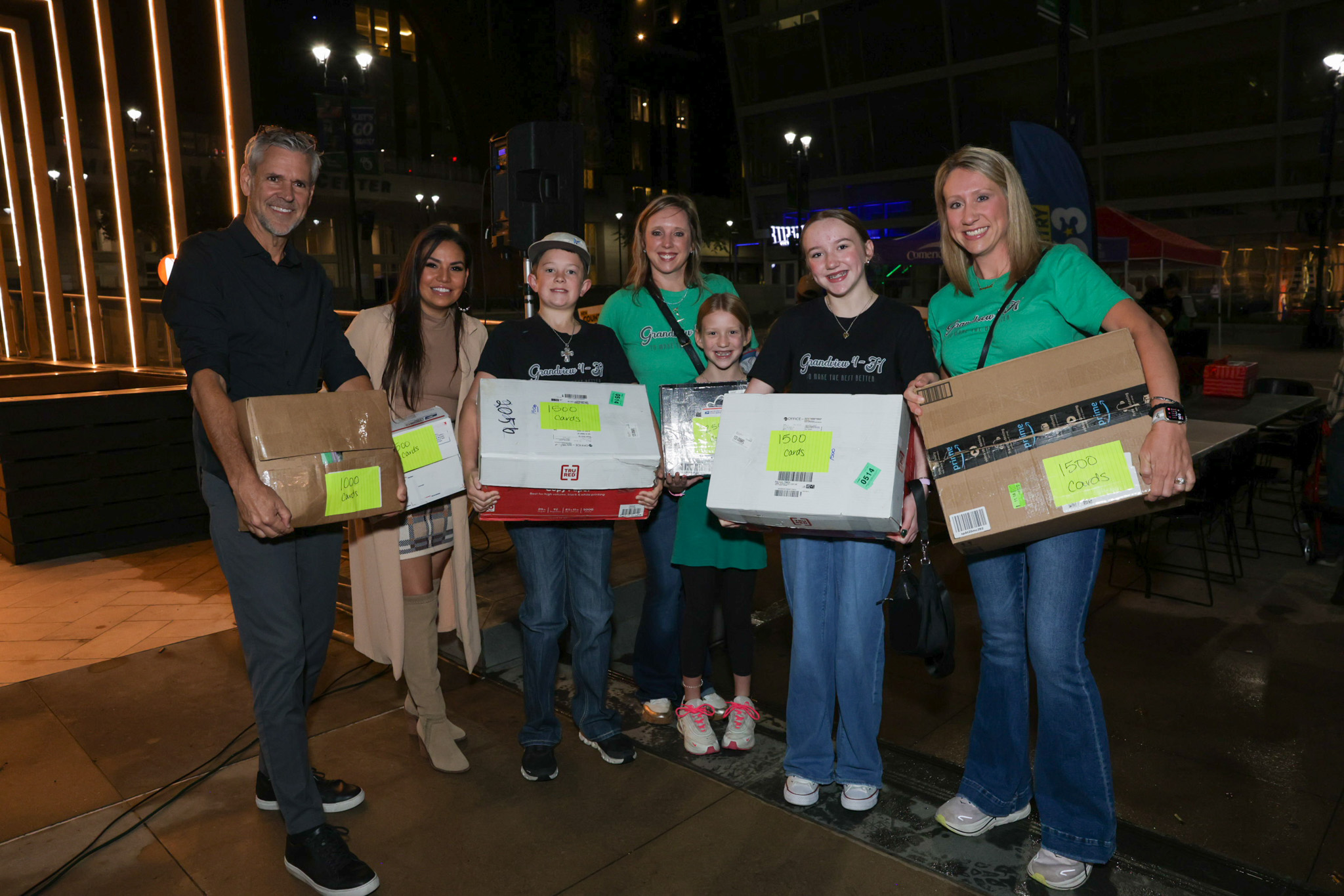 Hawkeye and Michelle with participants holding boxes of donated cards.