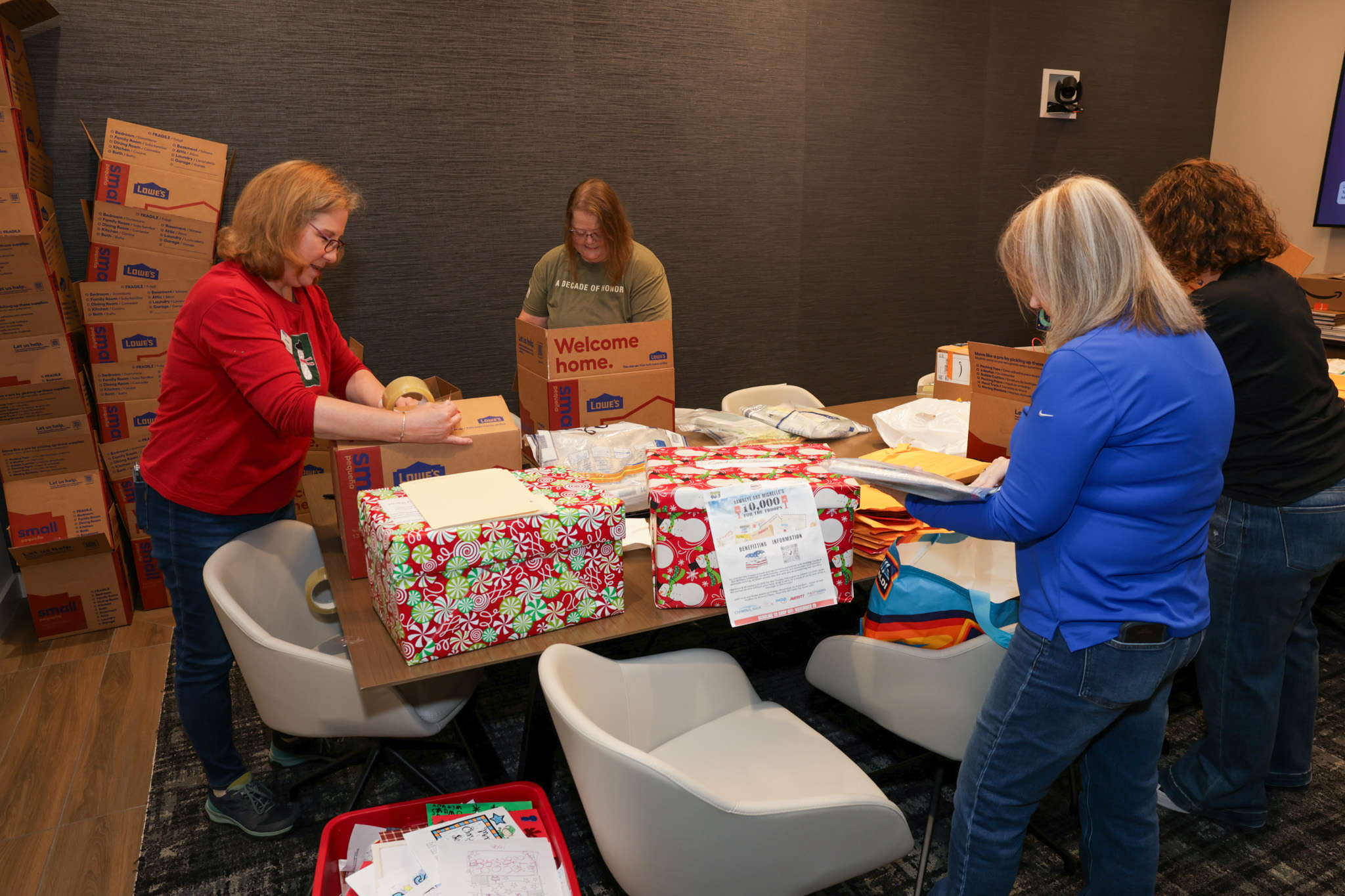 Volunteers sorting and packing holiday cards into boxes.
