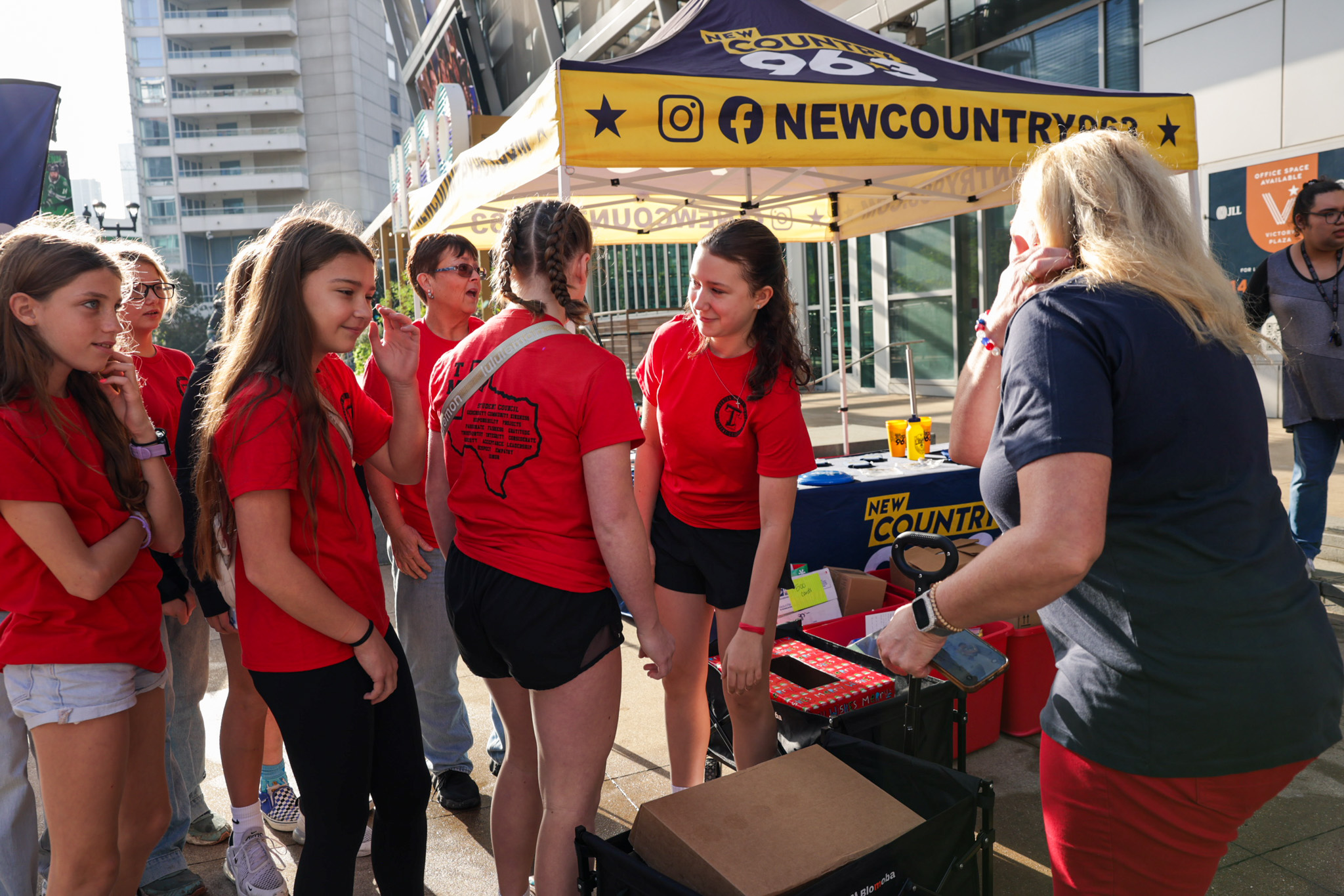 Young volunteers delivering cards at the New Country 96.3 collection tent.