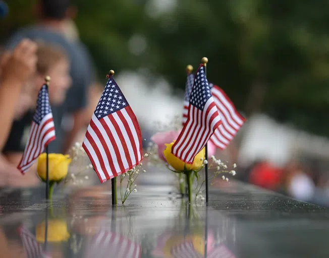 American flags and flowers at the "Ground Zero Memorial" in New York City.