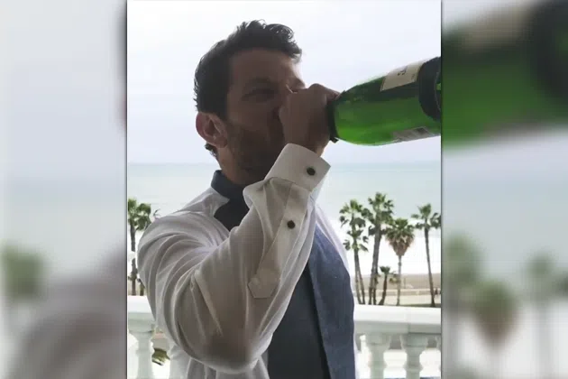 Brett Eldredge drinking a bottle of champagne
