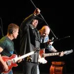 Eddie Montgomery and Montgomery Gentry band members on stage.