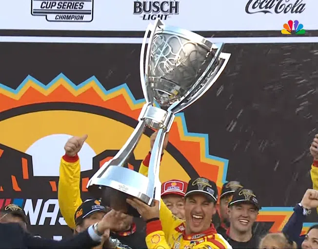Joey Logano holding up the 2024 NASCAR Cup Series Trophy at Phoenix Raceway 11-10-24