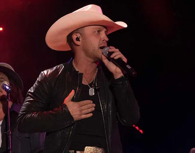 Justin Moore playing guitar on stage