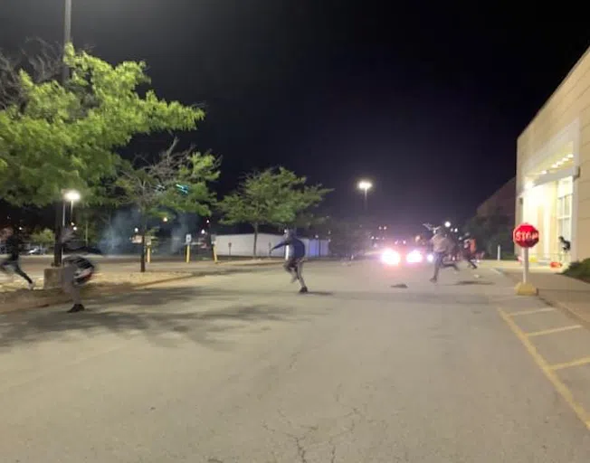 Looters run after police advance on the crowd. (Photo by A.J. Harris/WJBC)