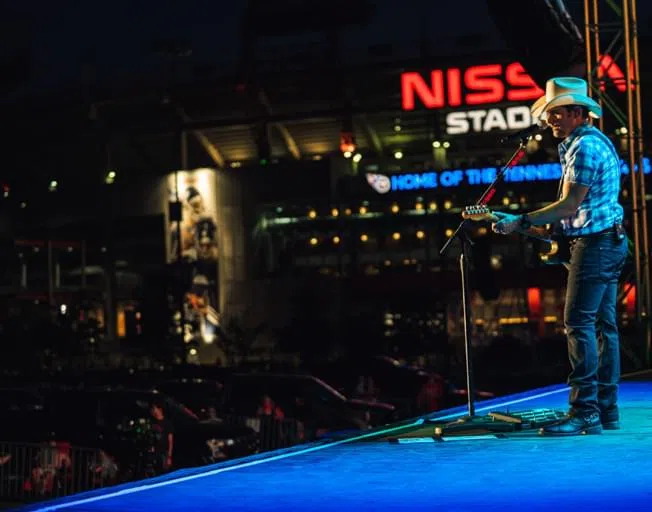 Brad Paisley on stage at a drive-in concert event.