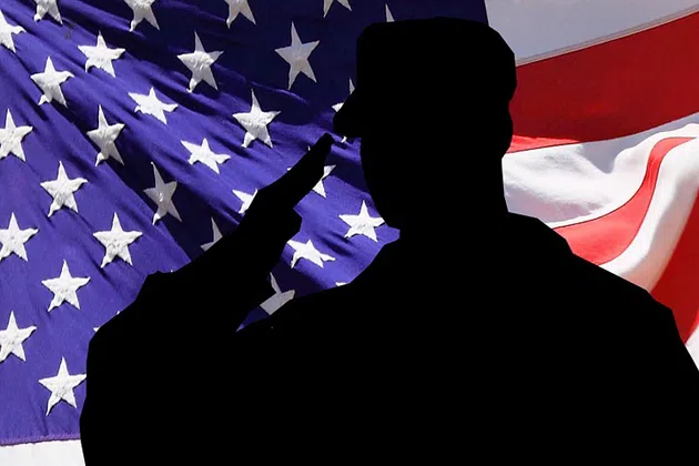 American flag and silhouette of soldier saluting