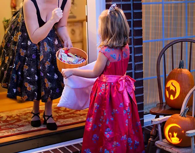 Young girl Trick or Treating on Halloween