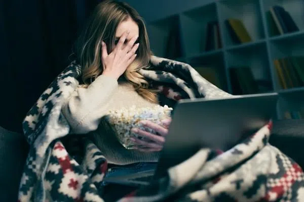 women watching scary movie on laptop