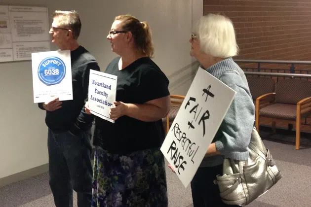 Members of the Heartland Faculty Association protest outside of the Heartland Community College board of trustees meeting Tuesday. (Joe Ragusa/WJBC)