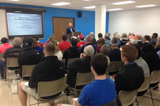 ISU professor Jason Ingram presents his research on the subject of police force during a discussion held by the ACLU Wednesday at the Normal Public Library. (Joe Ragusa/WJBC)