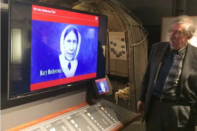McLean County Museum of History Executive Director Greg Koos displays a digital exhibit in 'Making a Home' which details the stories of those who have settled in McLean County. (Photo by Eric Stock/WJBC)