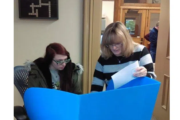 Macey Coppinger getting electronic voting instructions from Livingston County Clerk Kristy Masching.