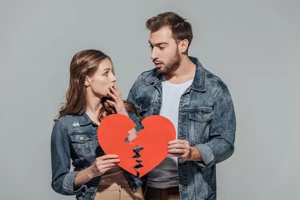 couple holding a broken heart