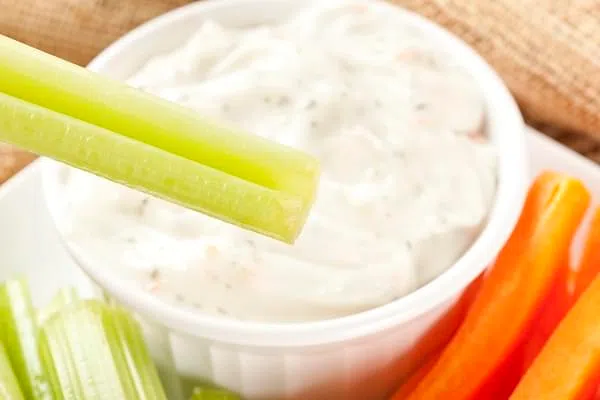 Organic Crunchy Celery and ranch dip on a background