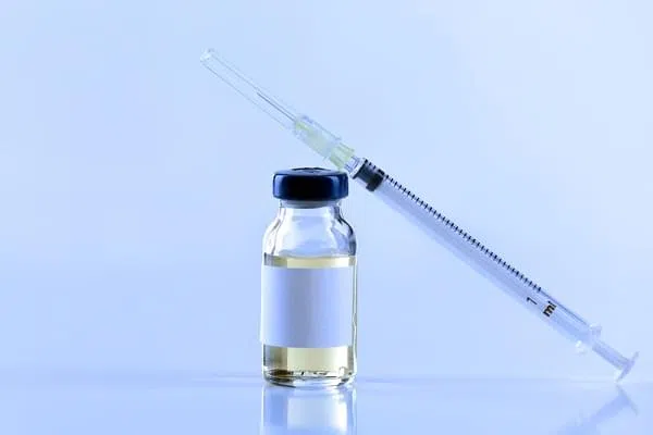 Vaccine in vial with syringe