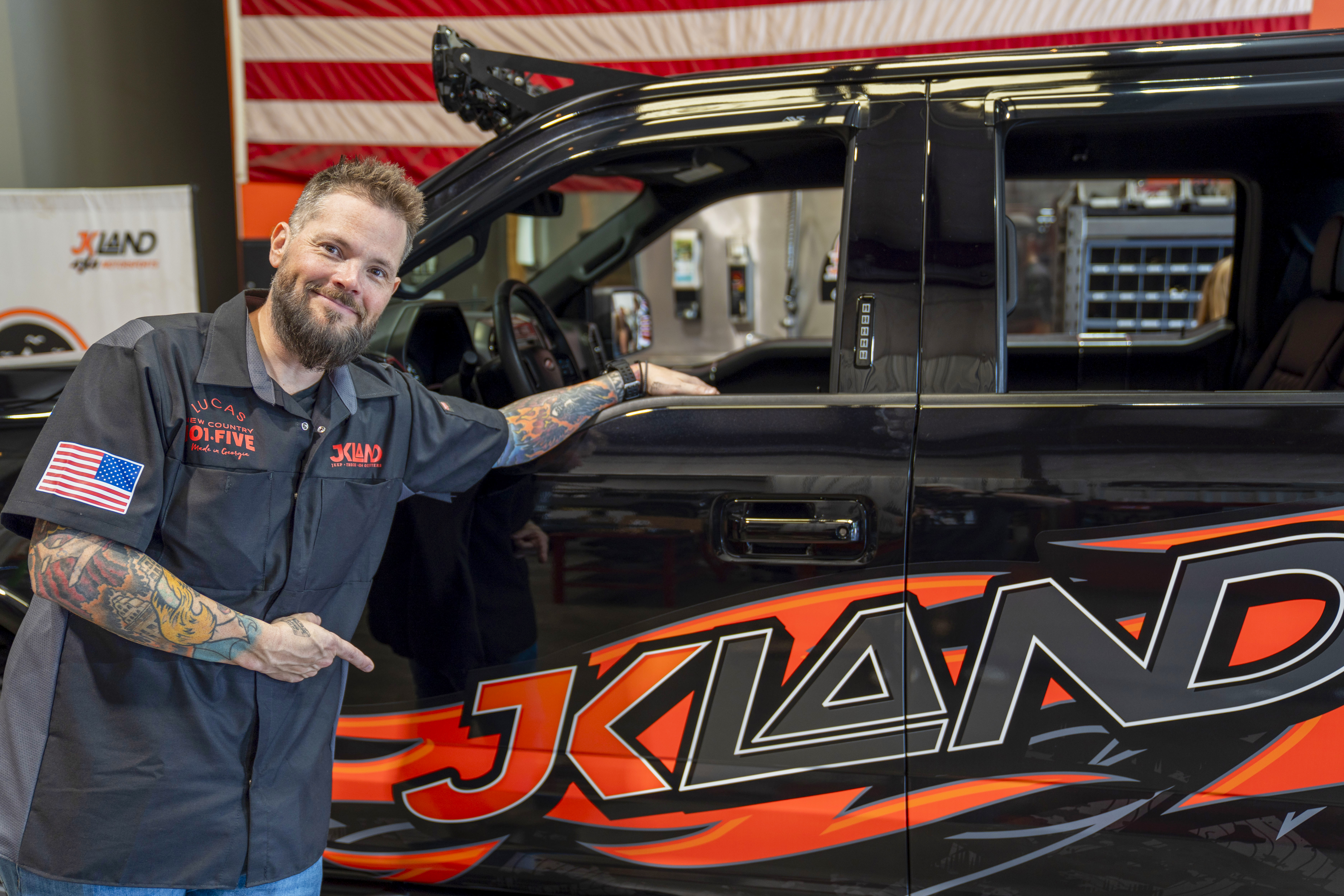 Custom red JKLand Jeep Wrangler on oversized off-road tires