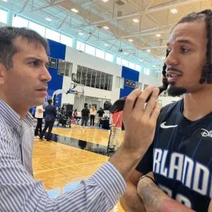 Photo of Mark Moses speaking to a player
