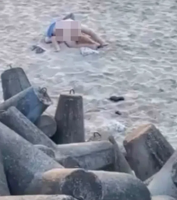 A randy couple were filmed having sex in front of stunned onlookers on a beach in the Polish seaside town of Mielno