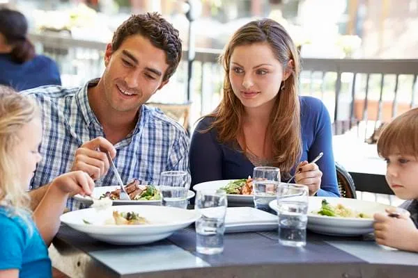 Family Enjoying Meal At Outdoor Restaurant