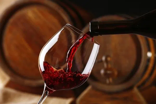 red wine pouring into glass