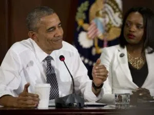 President Barack Obama, joined by Brittany Packnett, of the President's Taskforce on 21st Century Policing, right, pauses as he speaks to media at the bottom of a meeting at the Eisenhower Executive Office Building on the White House complex in Washington, Wednesday, July 13, 2016, about community policing and criminal justice with a group made of activists, civil rights, faith, law enforcement and elected leaders. (AP Photo/Carolyn Kaster)
