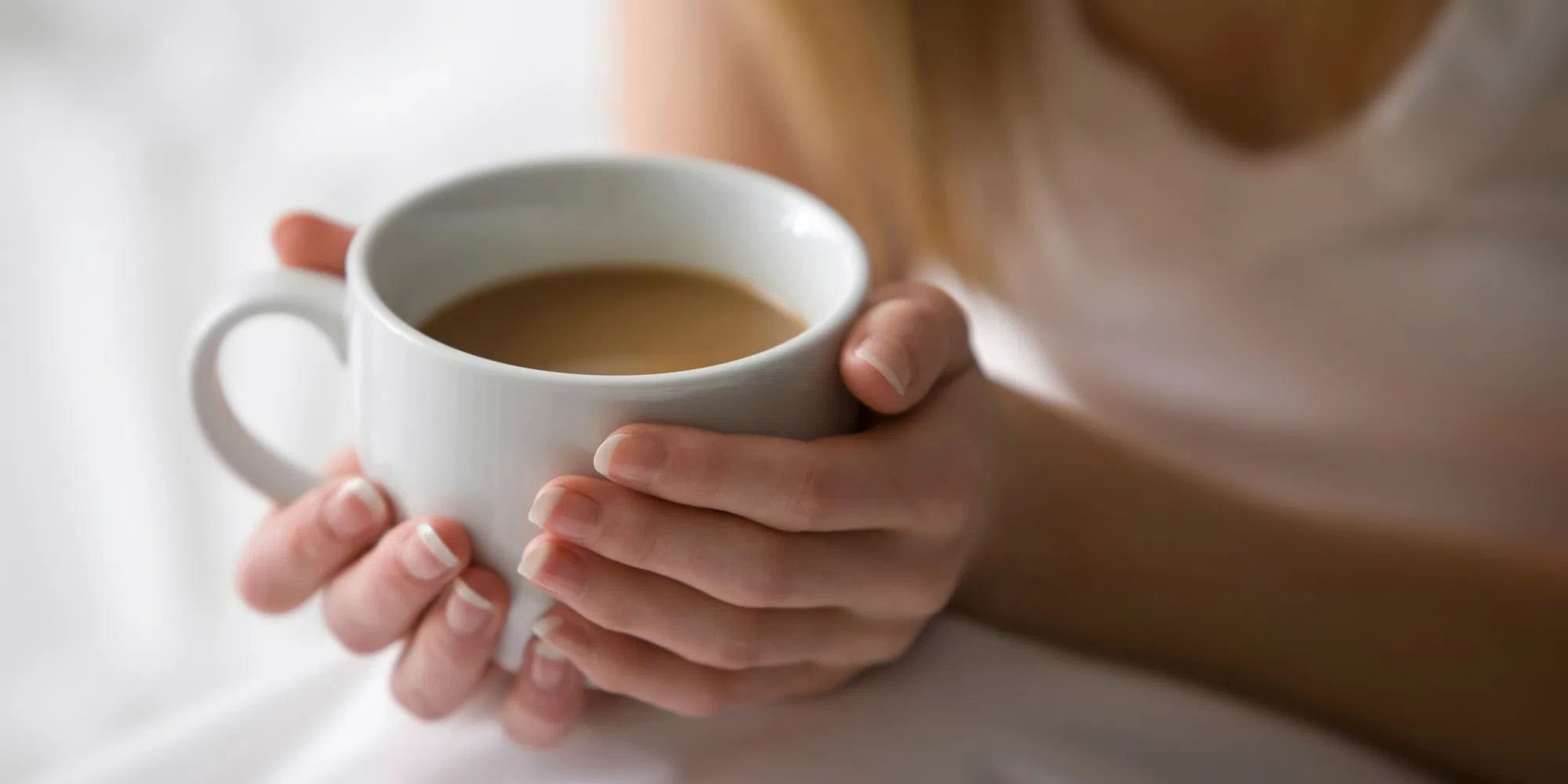 Caucasian woman holding cup of coffee