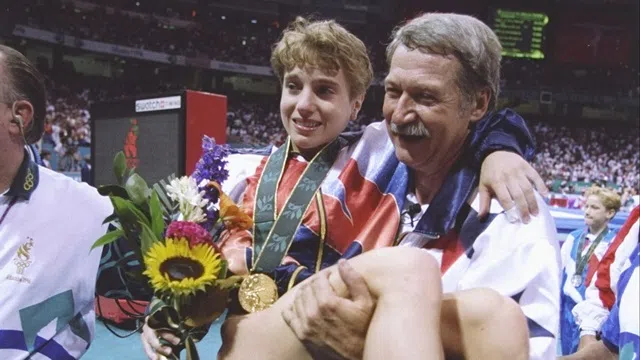 23 Jul 1996: Bela Karolyi carries Kerri Strug off the floor during the Olympic Games at the Georgia Dome in Atlanta, Georgia. Mandatory Credit: Mike Powell /Allsport