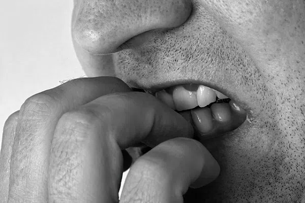 man biting his nails