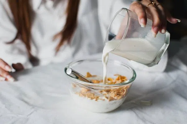 pouring milk into cereal