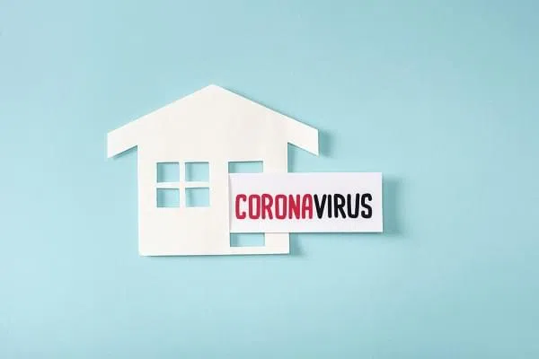 house with a paper that reads coronavirus