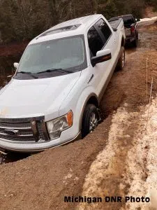 A pickup truck dropped into a ditch when an access road to Arfelin Lake failed in Marquette County.