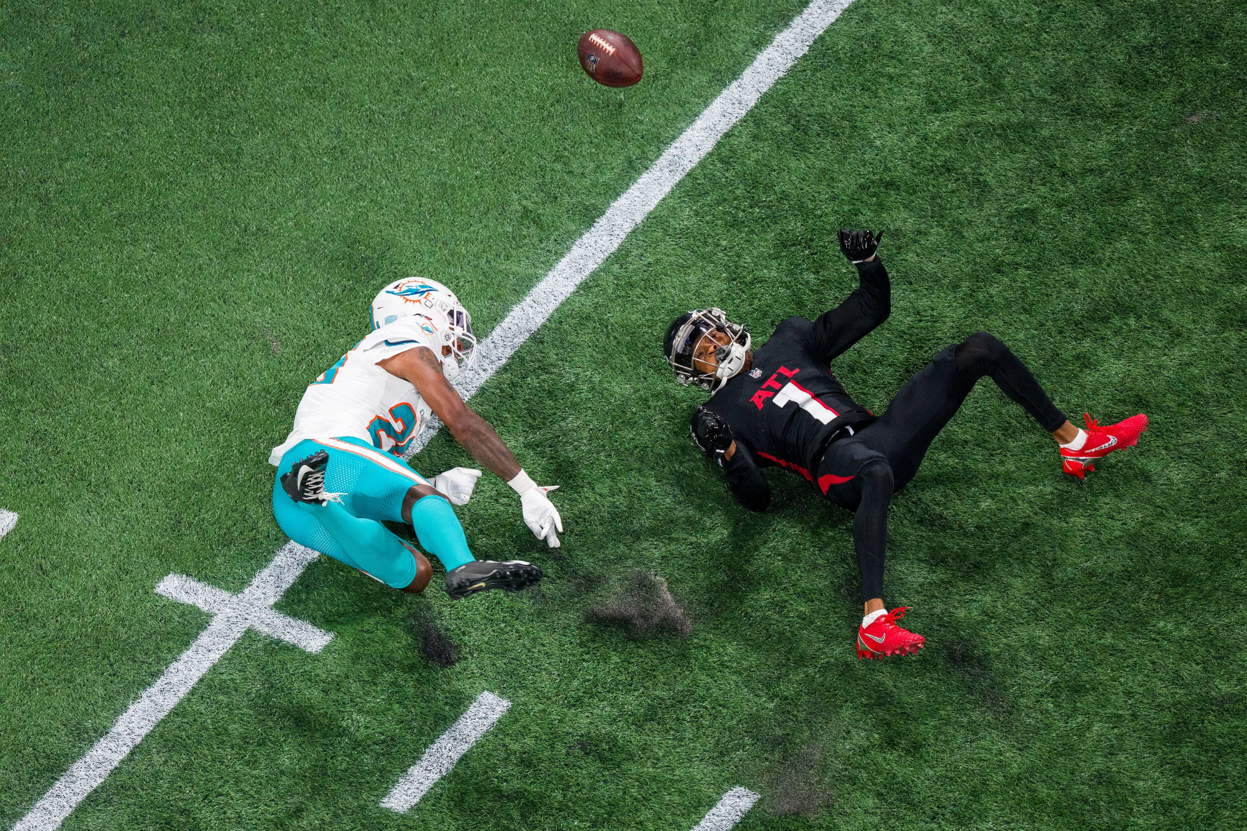 Atlanta Falcons wide receiver Darnell Mooney (1) attempts to catch a pass as Miami Dolphins cornerback Rasul Douglas (26) defends during the second half of an NFL football game